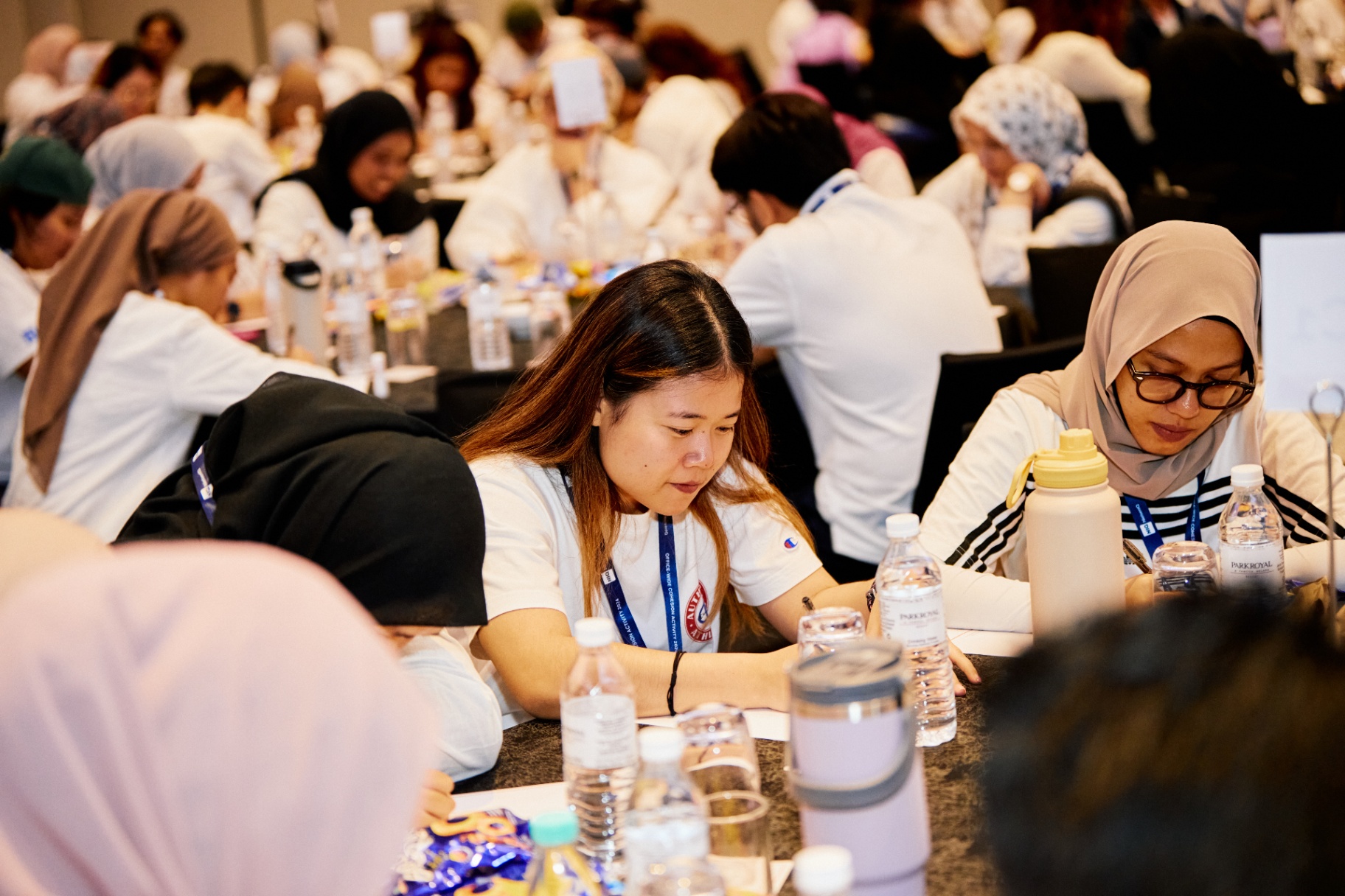 Wesley Chan facilitating a hands-on workshop discussion in a corporate training room