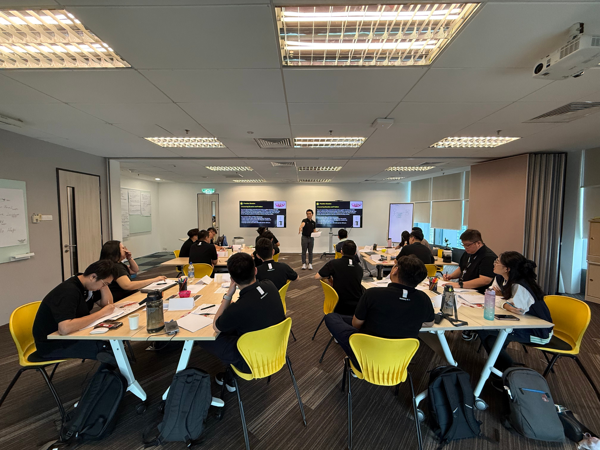 Wesley Chan leading a full-classroom practice session with participants at their tables